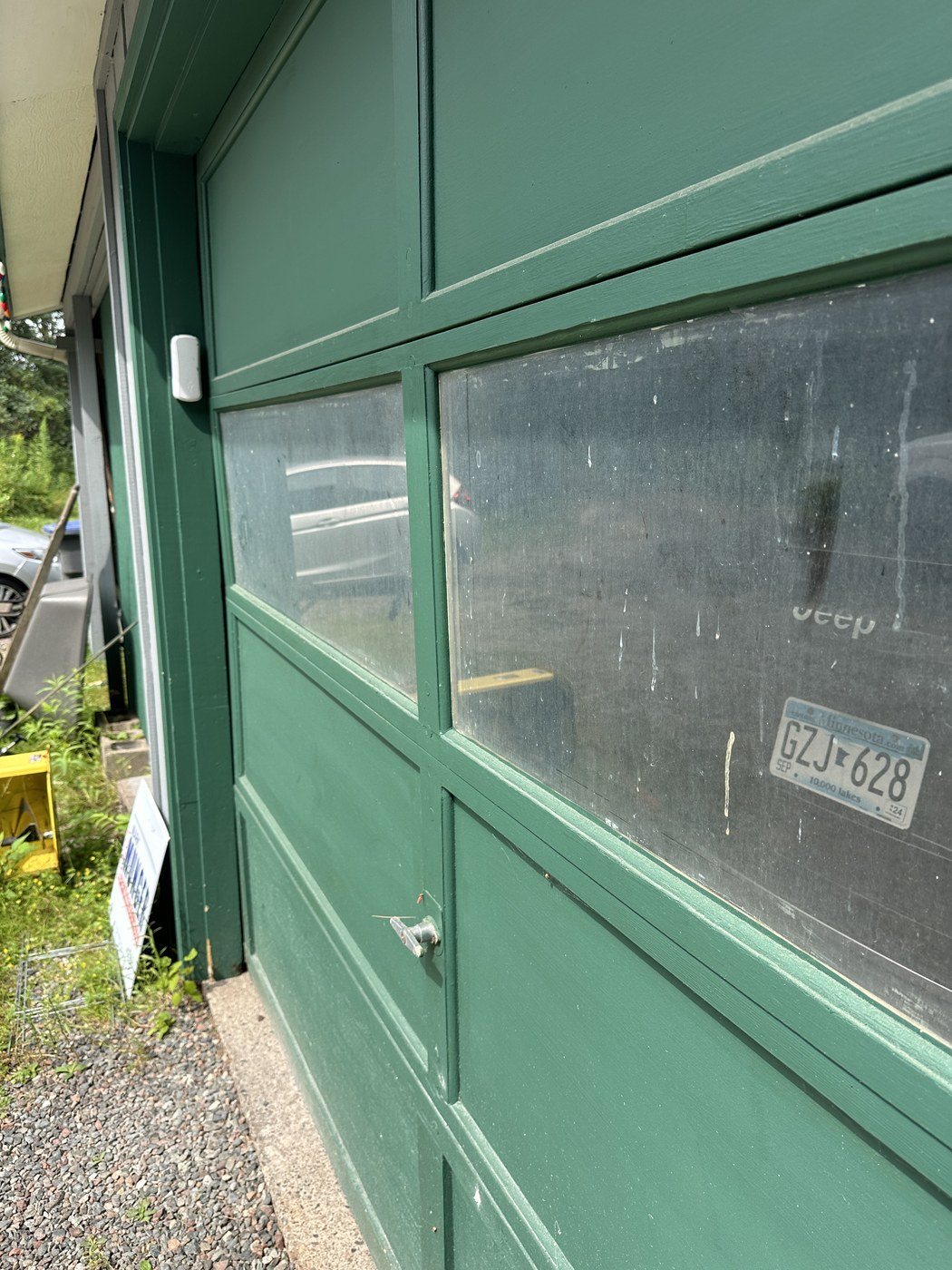 Before: Garage door glass you can see through again on a North Shore home
